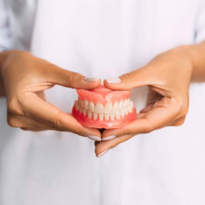 Lady presents dentures