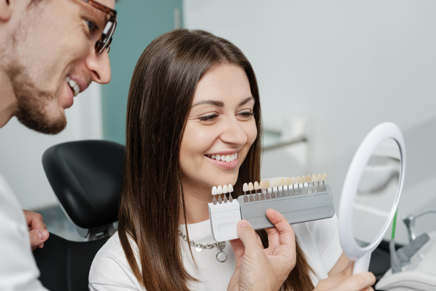 Dentist showing patient veneer options